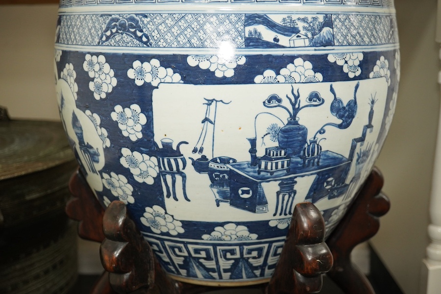 A large Chinese blue and white ‘Hundred Antiques’ jardinere and hongmu stand, late 19th/early 20th century